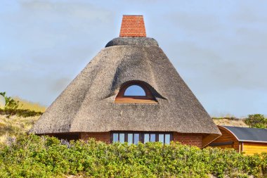 A beautiful shot of a thatching house rooftop clipart
