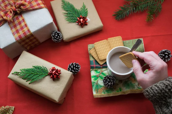 Eine Hand Taucht Neben Weihnachtsgeschenken Einen Keks Eine Tasse Mit — Stockfoto