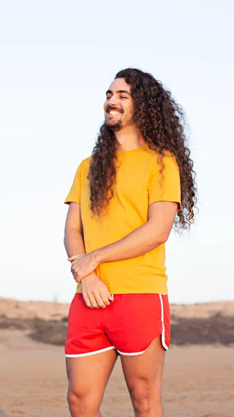 Vertical Shot Young Man Long Curly Hair Standing Beach — Stock Photo, Image