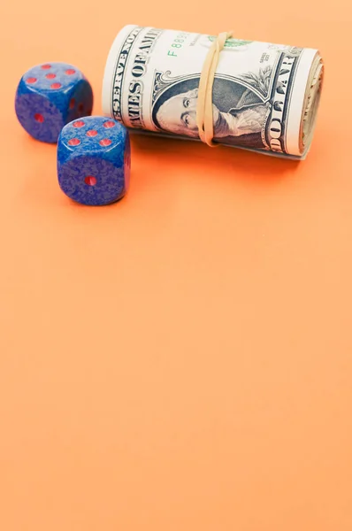 Vertical Shot Rolled Dollar Bills Dices Orange Surface — Stock Photo, Image