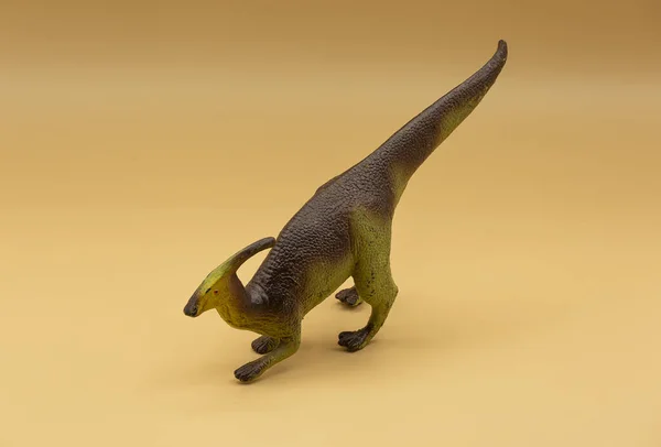 Zbliżenie Plastikowej Zabawki Dinozaura Izolowane Beżowym Tle — Zdjęcie stockowe