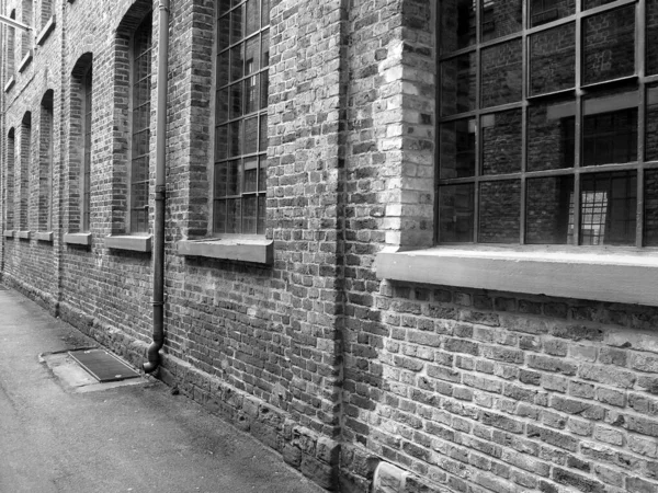 Grayscale Shot Old Brick Wall Building Glass Windows — Stock Photo, Image
