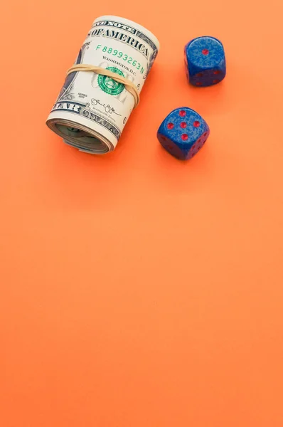 Vertical Shot Rolled Dollar Bills Dices Orange Surface — Stock Photo, Image