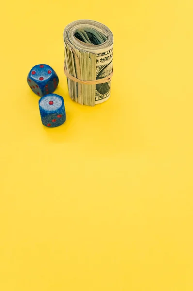 Vertical Shot Rolled Dollar Bills Dices Yellow Surface — Stock Photo, Image
