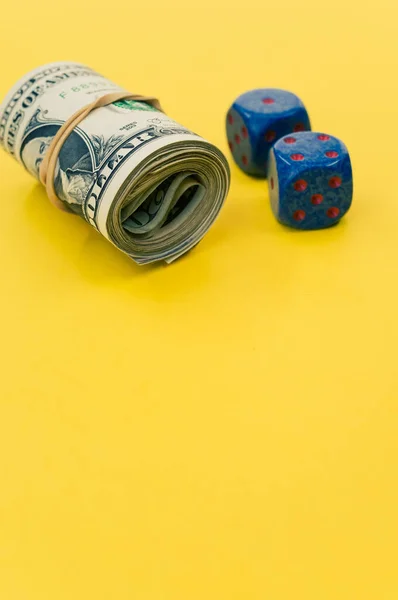 Bundle Rolled American Banknotes Two Blue Dice Isolated Yellow Background — Stock Photo, Image