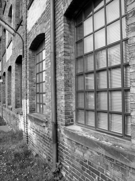 Grayscale Záběr Staré Cihlové Zdi Skleněnými Okny — Stock fotografie