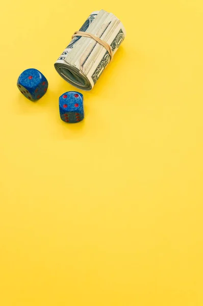 Vertical Shot Rolled Dollar Bills Dices Yellow Surface — Stock Photo, Image
