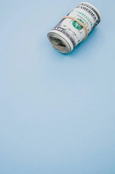 Vertical Shot Rolled Dollar Bills Blue Surface — Stock Photo, Image