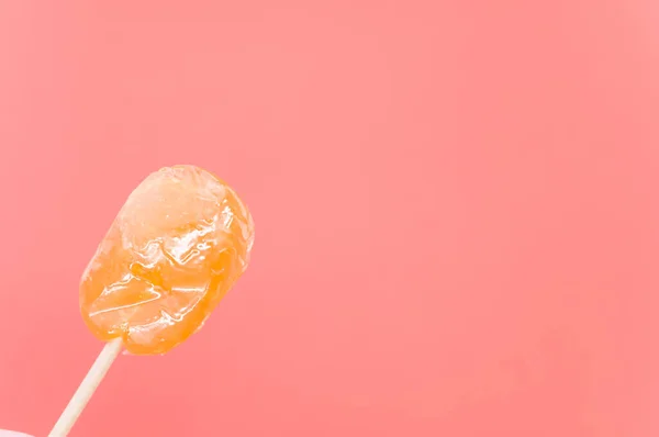 Closeup Shot Orange Flavored Lollipop Isolated Pink Background — Stock Photo, Image