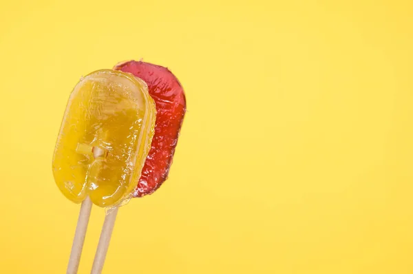 Closeup Shot Yellow Red Flavored Lollipops Isolated Yellow Background — Stock Photo, Image