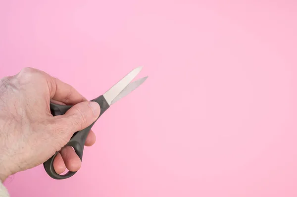 Closeup Shot Hand Holding Black Scissors Isolated Pink Background — Stock Photo, Image