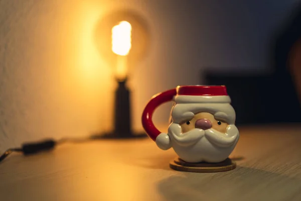 Eine Weihnachtstasse Mit Dem Kopf Des Weihnachtsmannes Auf Einem Holztisch — Stockfoto
