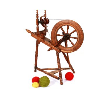 A closeup shot of an old wooden spinning wheel with balls of yarn isolated on white background clipart