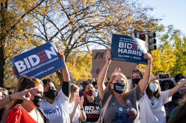 WASHINGTON D.C, UNITED STATES - Nov 09, 2020: Washington D.C./USA- November 7th, 2020: People holding Biden signs outside the White House. clipart