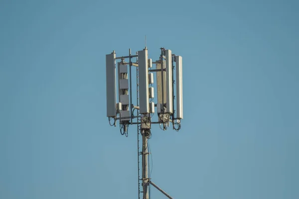在蓝天背景上隔离的通信塔的一个低角度的照片 — 图库照片