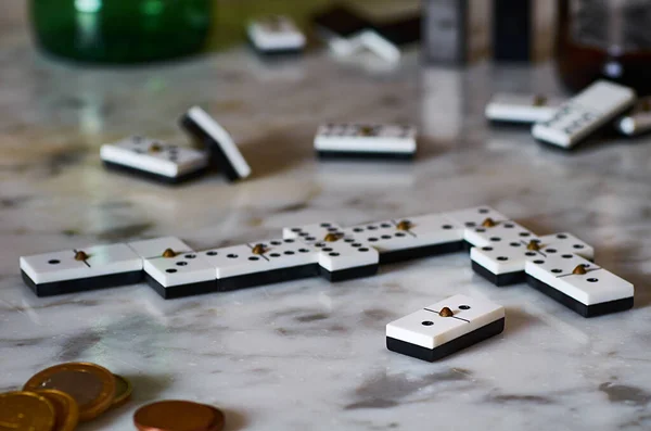 A selective focus shot of playing dominos on a marble table