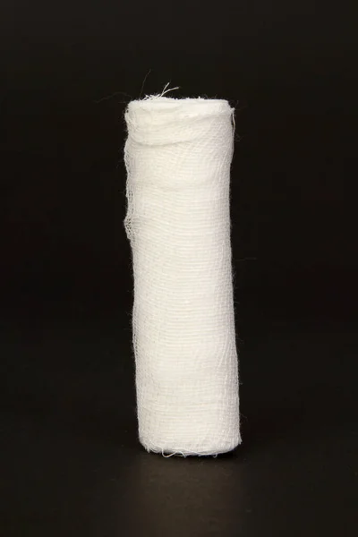 Tiro Close Vertical Uma Bandagem Uma Superfície Preta — Fotografia de Stock