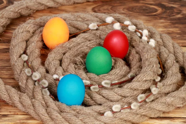 Closeup Four Colorfully Decorated Eggs Placed Rope Wooden Table — Stock Photo, Image