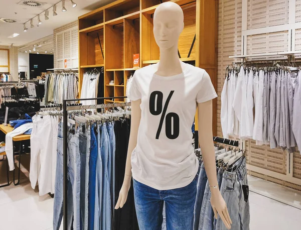 A closeup shot of a mannequin with a sale icon on it in the shop - shopping concept