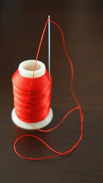 Pull thread into needle Stock Photos, Royalty Free Pull thread into needle  Images