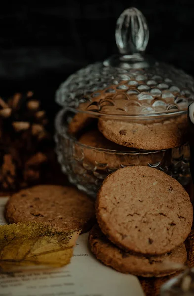 A vertical shot of tasty cookies in a jar in an autumn decoration set