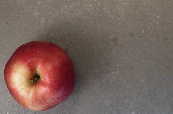 Gri Bir Yüzeye Yerleştirilmiş Büyük Sulu Kırmızı Bir Elmanın Üst — Stok fotoğraf