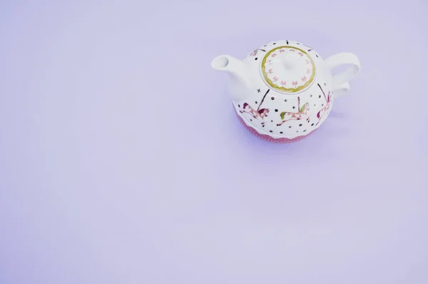 stock image A top view of a decorative teapot isolated on purple background