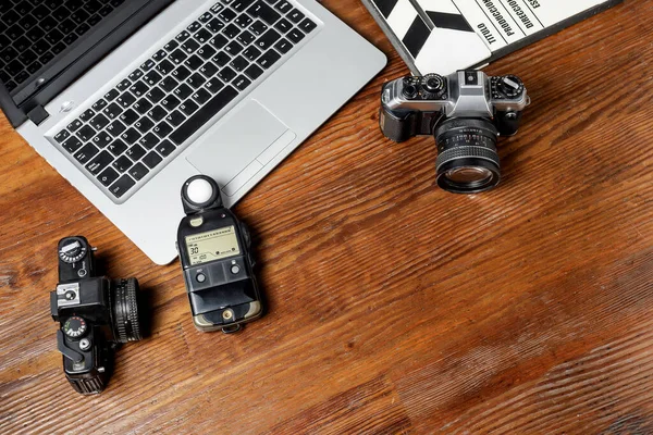 Top View Closeup Cameras Notebook Photometer Movie Clapperboard Wooden Table — Stock Photo, Image