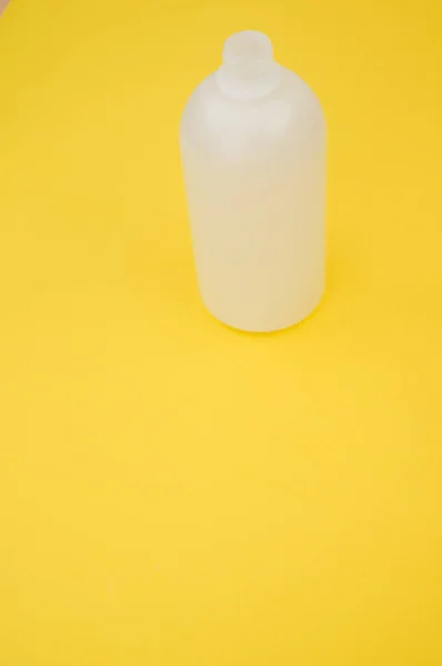 Disparo Vertical Una Botella Plástico Sobre Fondo Amarillo —  Fotos de Stock