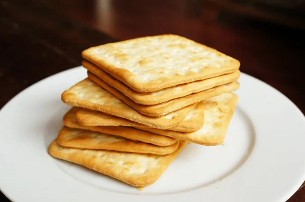 Top View Closeup Healthy Salted Crackers White Plate Wooden Table — Stock Photo, Image