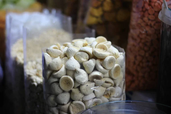 A closeup shot of a bowl of white truffle candies