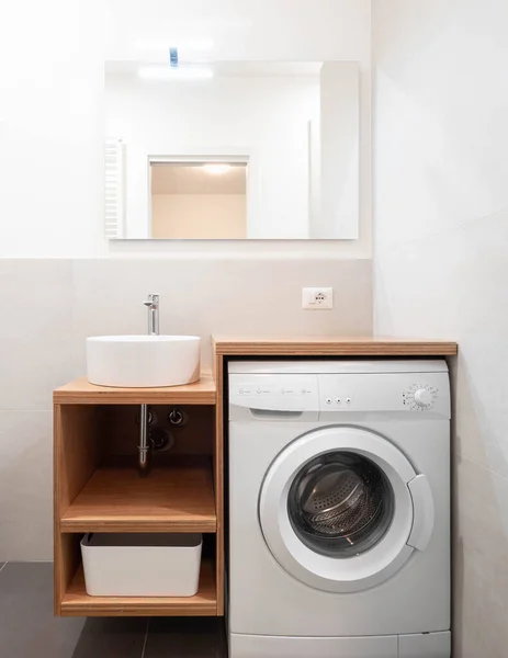 A modern laundry room with washing machine, small bathroom laundry at home