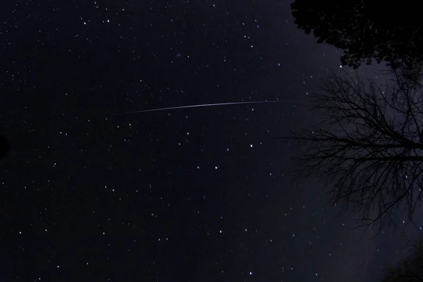 the Leonids meteorite shower, a single streak across a background of stars