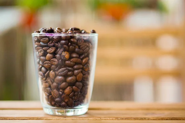 Selective Focus Shot Coffee Beans Transparent Cup Wooden Table — Stock Photo, Image