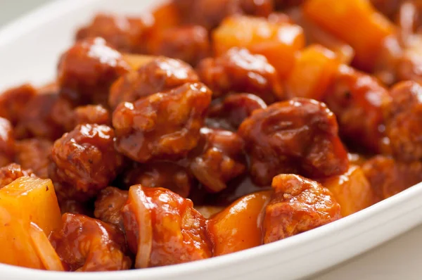 sweet and sour pork, a chinese take out food with pineapple and peppers