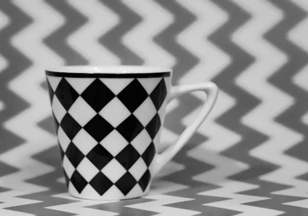 Grayscale Záběr Hrnečku Šachovým Vzorem Klikatém Pozadí — Stock fotografie