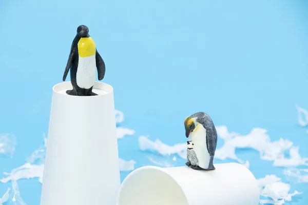 Selective Focus Shot Penguin Toys Paper Cups Surrounded Pieces Plastic — Stock Photo, Image