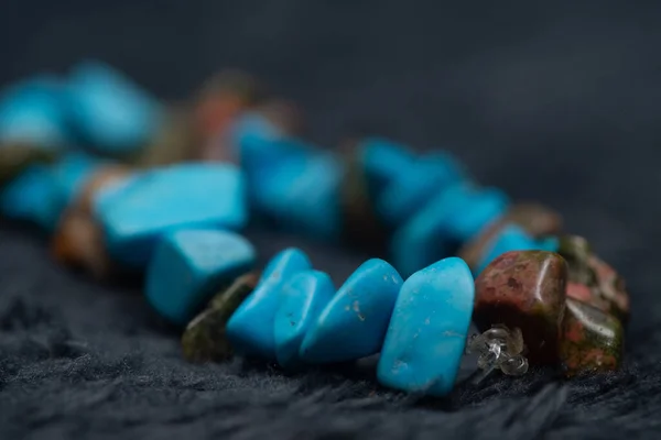 A turquoise gemstone bracelet with other colorful semi-precious stones
