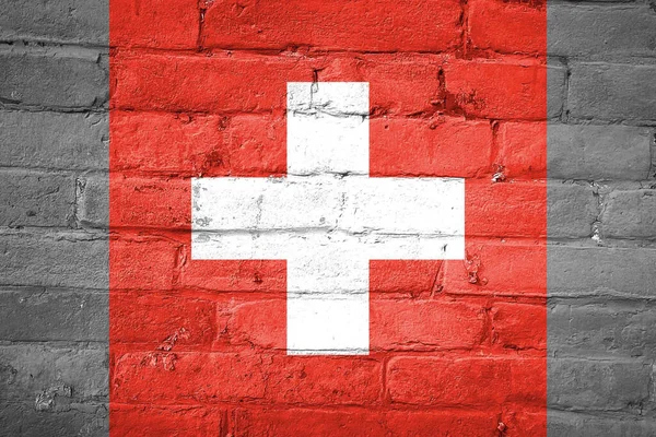 一幅挂在砖墙上的瑞士国旗照片 — 图库照片