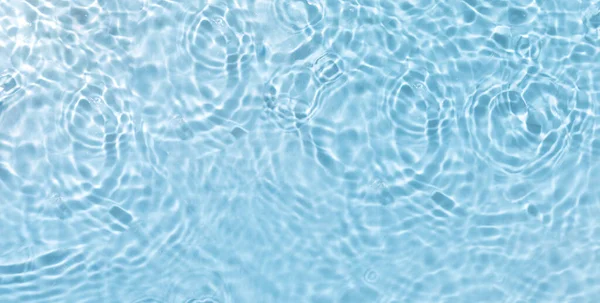 A high angle shot of water ripples on the surface of the water