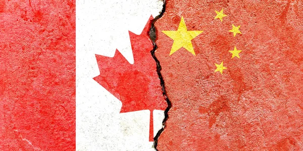 A Canadian and Chinese flag on a cracked wall-politics, war, conflict concept