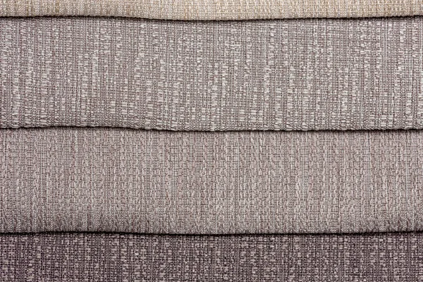 Gray colors in a set of comparison interior decoration sample swaps of textured curtain fabric with various shades creating a colorful backdrop evenly