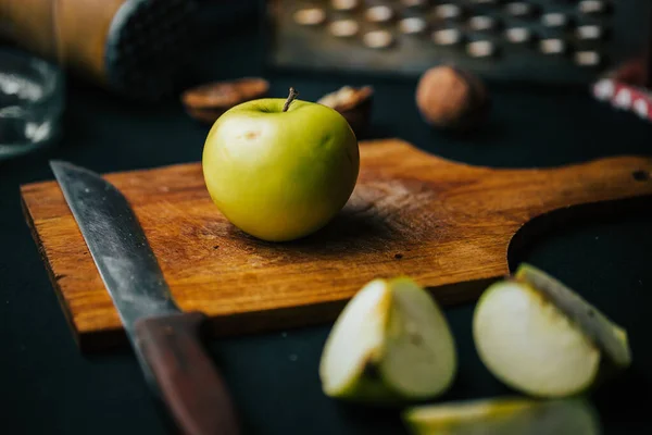 stock image A closeup of the fruit salad making process with apple and walnuts