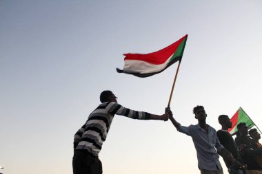 KHARTOUM, SUDAN - Dec 19, 2019: People celebrating the first anniversary of the revolution by he Constitutional Court and inside Liberty SquareThey ask retribution for the martyrs. clipart