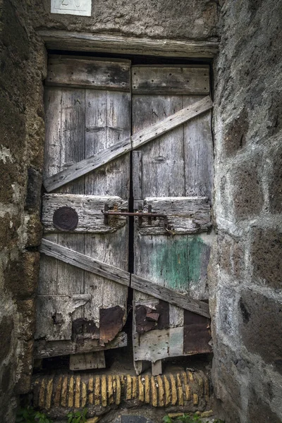 錆びた鍵をかけた木の扉の垂直ショット — ストック写真