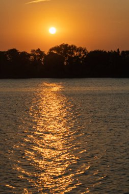 A vertical shot of a beautiful sunset over a lake in Tuxpan, Veracruz, Mexico clipart