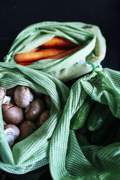 Vertical Closeup Shot Fresh Carrots Mushrooms Cucumbers Bags — Stock Photo, Image