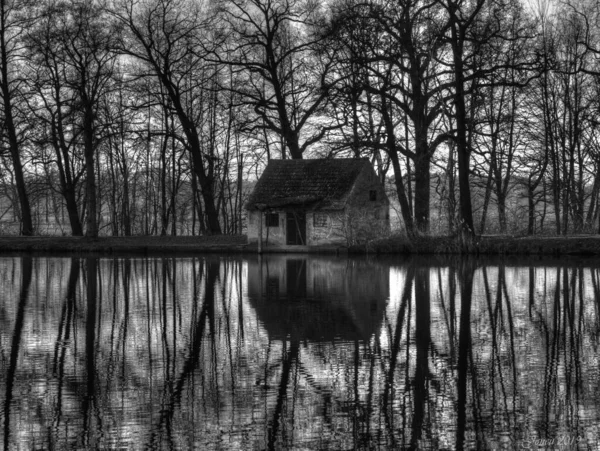 Grayscale Rural Building Next Trees Reflected Lake — Stock Photo, Image