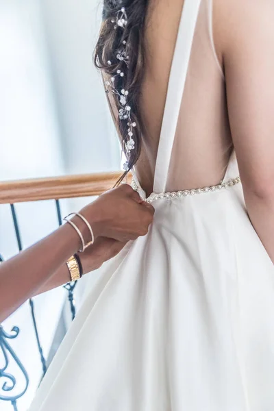 A mother helping her daughter prepare for her wedding