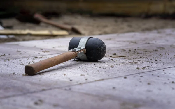 A rubber mallet fallen on the ground